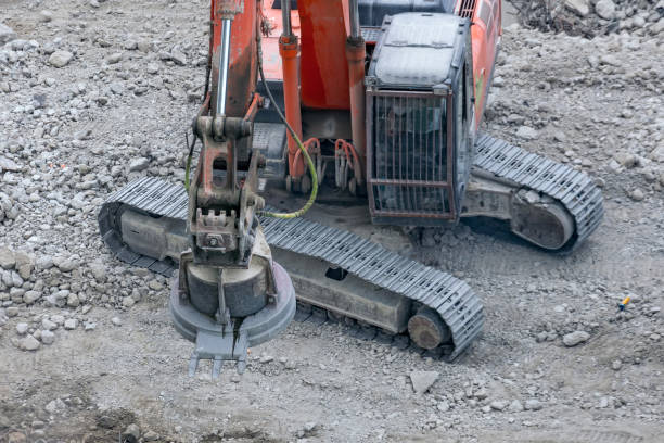 istock Magnetic crane loading scrap metals on the ruins of a construction site. 1207224616