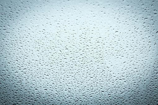 Water drops on glass, abstract background