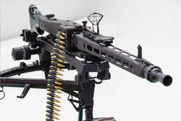 Photo of Black assault rifle weapon loaded with ammunition.