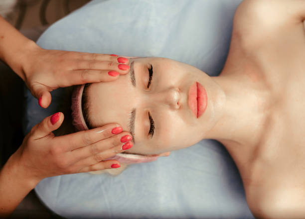 istock Therapist doing face massage on woman in the spa salon 1207226364
