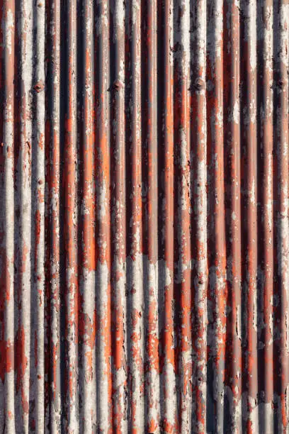 Photo of Weathered paint on corrugated metal surface