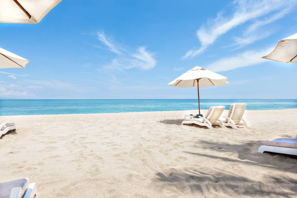 istock Ocean side chairs and umbrellas with blue sky 1207232476