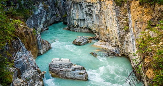 Mountain stream with beautiful turquoise coloured water flowing through Marble Canyon in Kootenay National Park. British Columbia - Canada