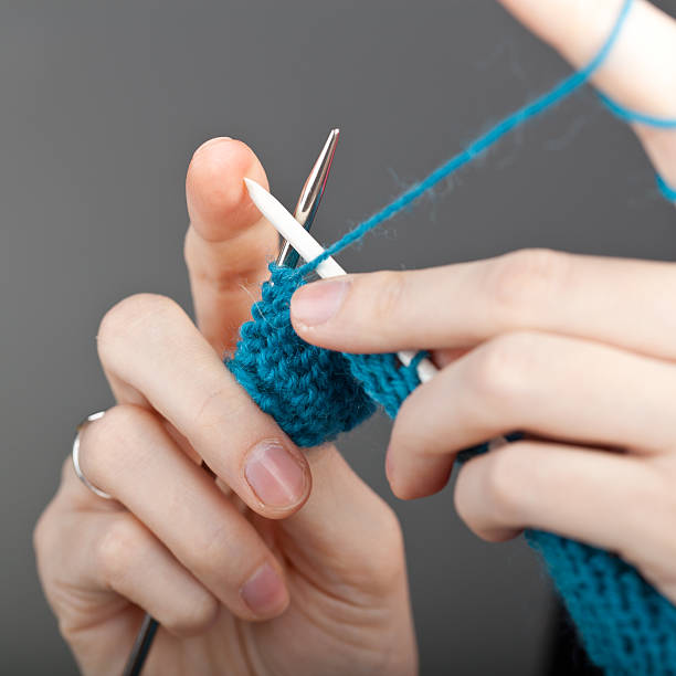 istock Hands of a young woman knitting 120723260