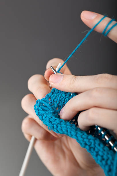 istock Hands of a young woman knitting 120723309