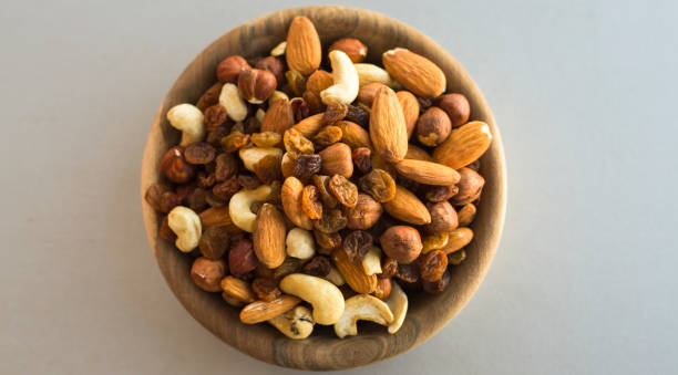 istock wooden bowl with mix nuts 1207233168