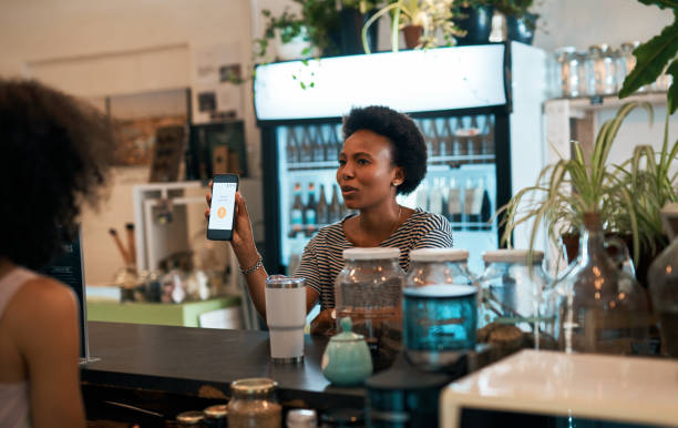 Should we try it again? Shot of a young woman taking an unsuccessful smartphone payment from a customer in her store insufficient funds stock pictures, royalty-free photos & images