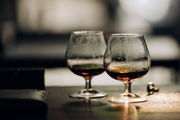 istock Two glasses with cognac on a dark background. Alcohol 1207236459