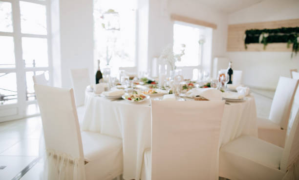 istock Dinner table decoration in white colors in the restaurant. Catering service 1207236558