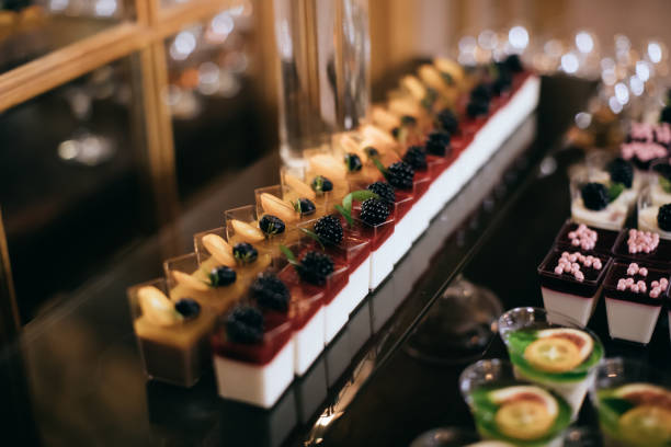 istock Delicious cakes with fresh berries on dessert table at wedding party 1207236605