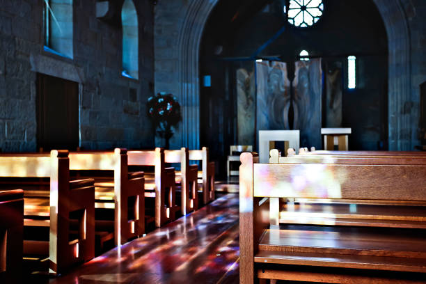 istock Church wooden chairs close up shining with light 1207236688