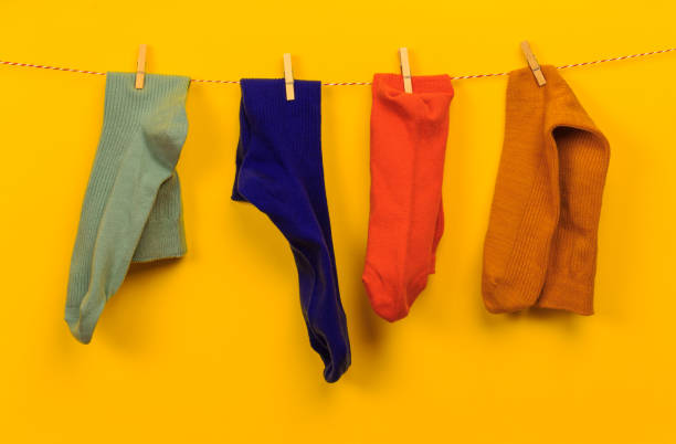 Colorful socks on a clothesline, isoated on white background