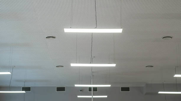 istock Fluorescent lights hanging from the ceiling inside the room. White walls. The lighting. 1207237041