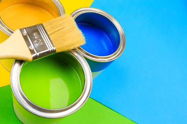 istock Metal paint cans and paint brushes on multicolor background. Top view. Copy space. 1207238799