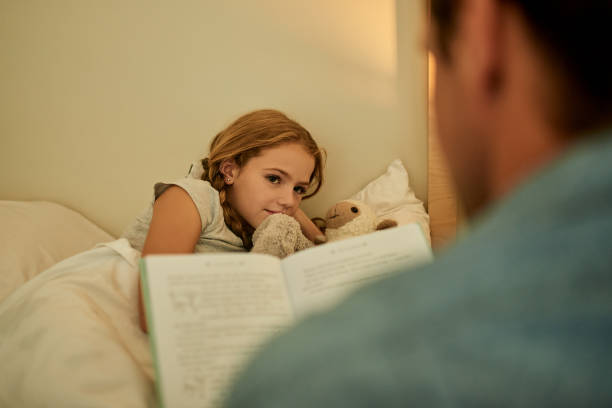 istock Dad always reads her favourite bedtime story 1207238829