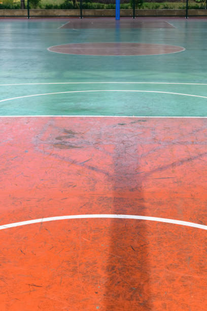 istock basketball frame shadow in an outdoor court vertical composition 1207238956