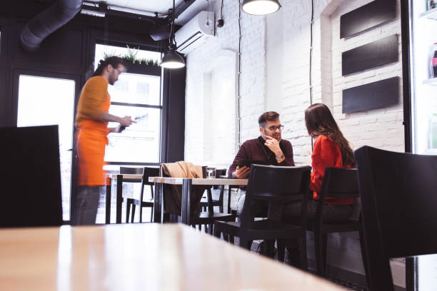 istock Waiter Takes Order From a young Couple 1207239783