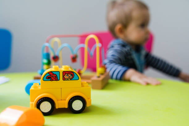 cute little boy playing with toys by the home