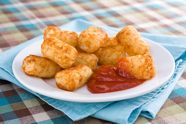 Tater Tots & Ketchup Deep-fried tater tots served with ketchup. hash brown stock pictures, royalty-free photos & images