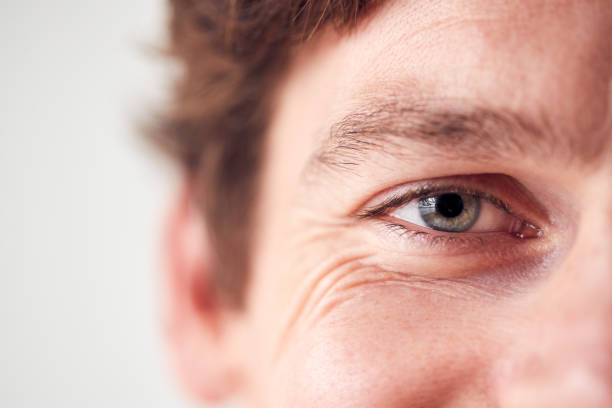 istock Close Up On Eyes Of Smiling Man Standing In Studio 1207245940