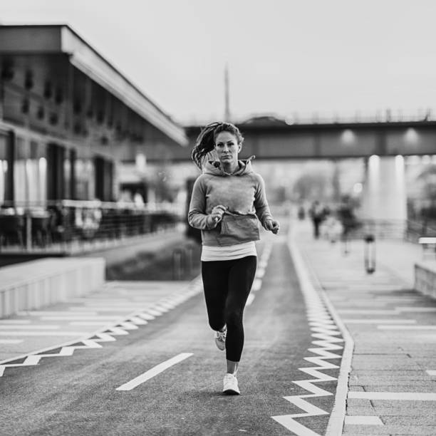 istock Woman jogging on riverside 1207248758
