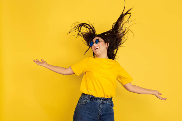 istock Caucasian woman's portrait isolated on yellow studio background 1207248768