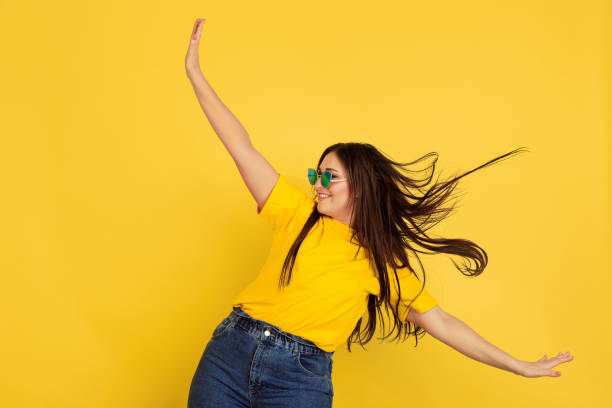 istock Caucasian woman's portrait isolated on yellow studio background 1207248793