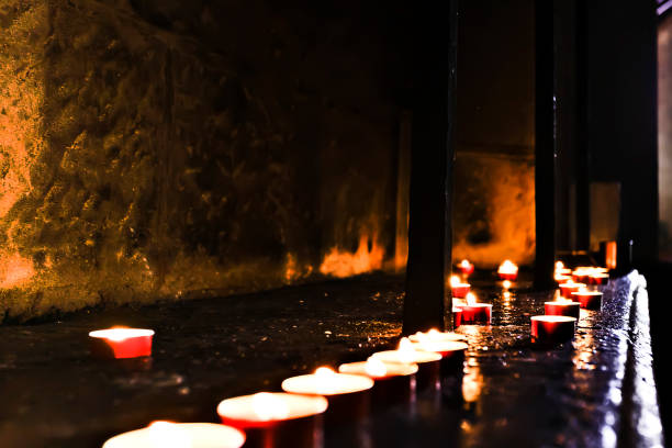istock Dark and dirty stone room with flashing candles 1207249588