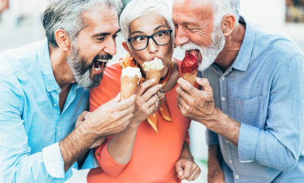 istock Happy senior friends eating ice cream 1207250007
