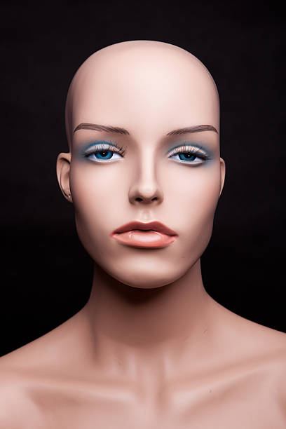 Woman in room with male mannequins