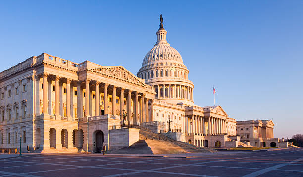 istock Rising sun illuminates the front of Capitol building in DC 120725263