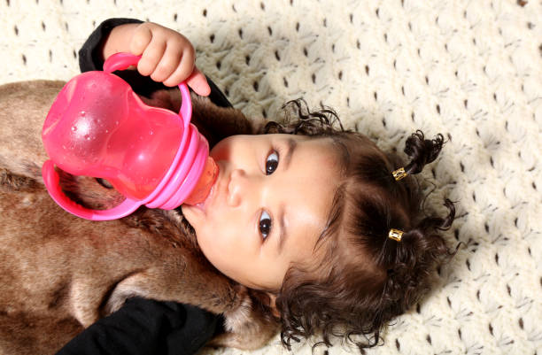 Six month old baby lying down.