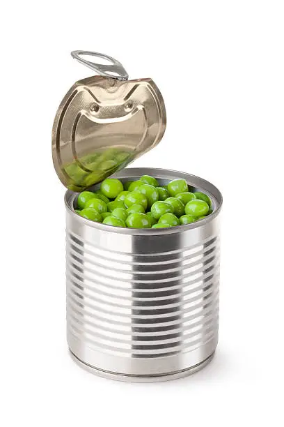 Opened metallic can with green peas. Isolated on white.
