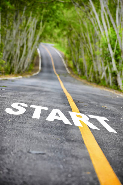 istock Tree tunnel with start word on asphalt road surface 1207255293