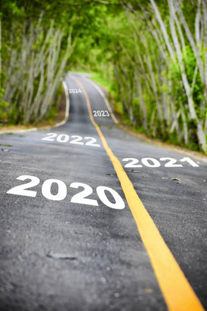 istock Tree tunnel with 2020 to 2024 on asphalt road surface 1207255881