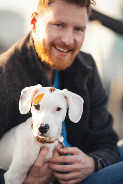 istock Handsome young man spending time with his dog 1207256110