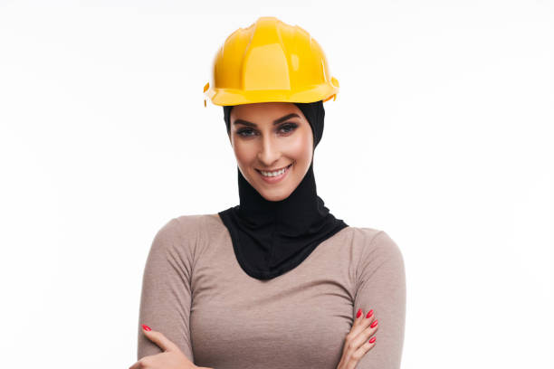 istock Muslim woman in helmet over white background 1207256399