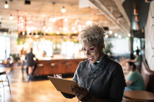 istock Tattooed businesswoman using digital tablet at work 1207256402