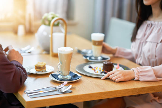 istock Young Couple Enjoying Coffee And Cake In Cafe 1207256458