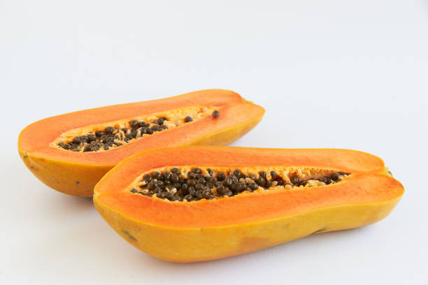 istock Two sliced papaya on white background 1207256554
