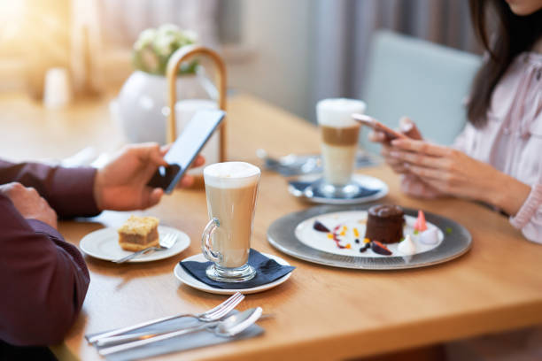 istock Young Couple Enjoying Coffee And Cake In Cafe 1207256658