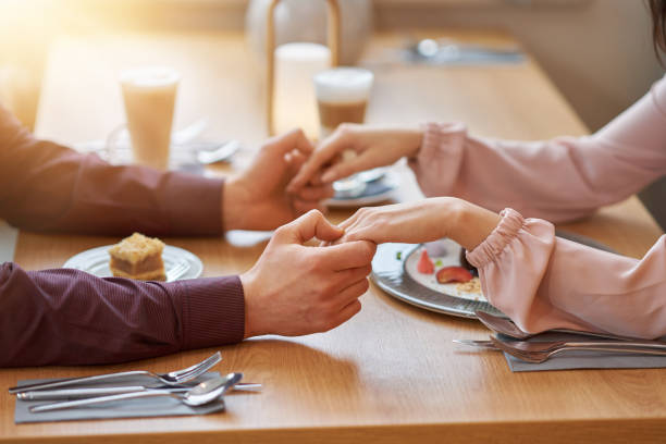 istock Young Couple Enjoying Coffee And Cake In Cafe 1207257194