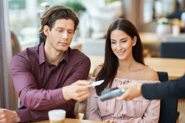 istock Young Couple paying by credit card in Cafe 1207257434