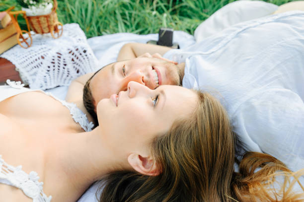 istock happy couple have fun in the park on nature. 1207257523