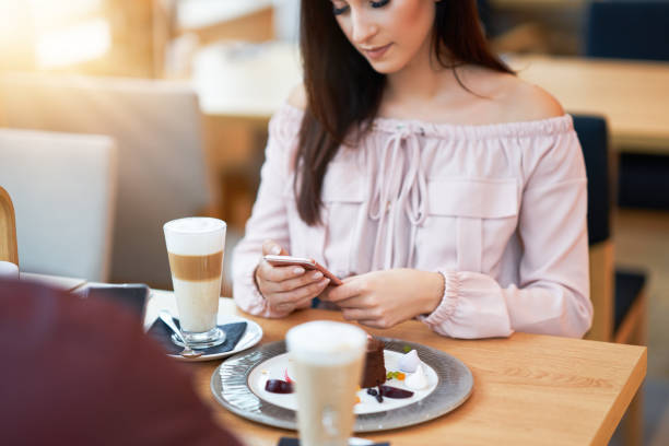 istock Young Couple Enjoying Coffee And Cake In Cafe 1207258064