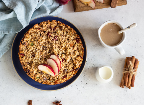 Oatmeal cake or baked oatmeal with apples and raisin. Dietary autumn pastries, healthy breakfast.