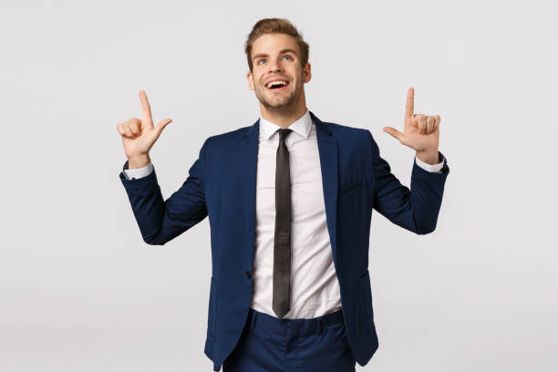 istock Dreamy, optimistic businessman seeing prosperity chance, smiling and looking up excited, contemplate beautiful scenery, captured attention on product promo, standing glad white background 1207259422