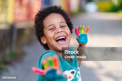 istock beautiful happy boy with painted hands 1207261035