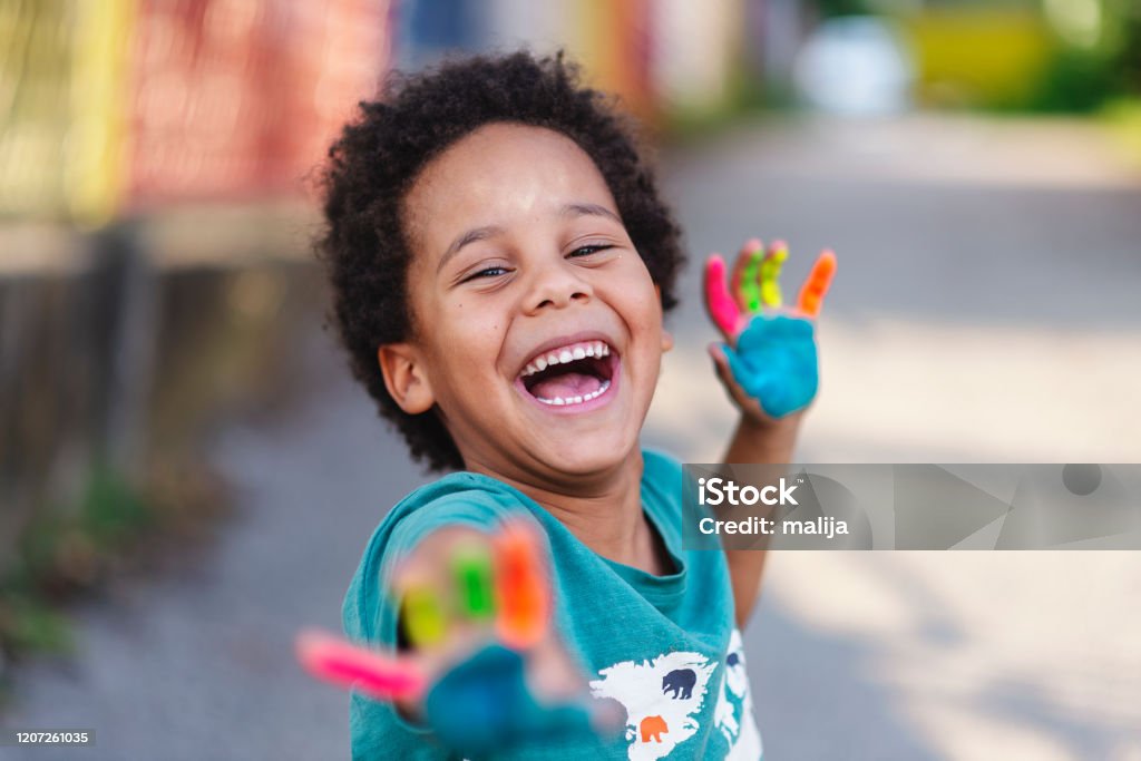 beautiful happy boy with painted hands beautiful happy boy with painted hands, artistic, educational, fun concepts Child Stock Photo