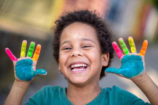 istock beautiful happy boy with painted hands 1207261172
